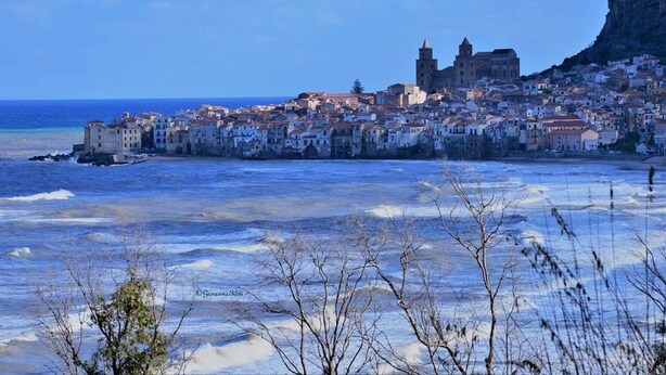 A coastal town with buildings along the shore, a prominent church, and a cliff in the background. - Rome Suite. Within walking distance of the sea, and the heart of beautiful Cefalù.  (Cefalù)
