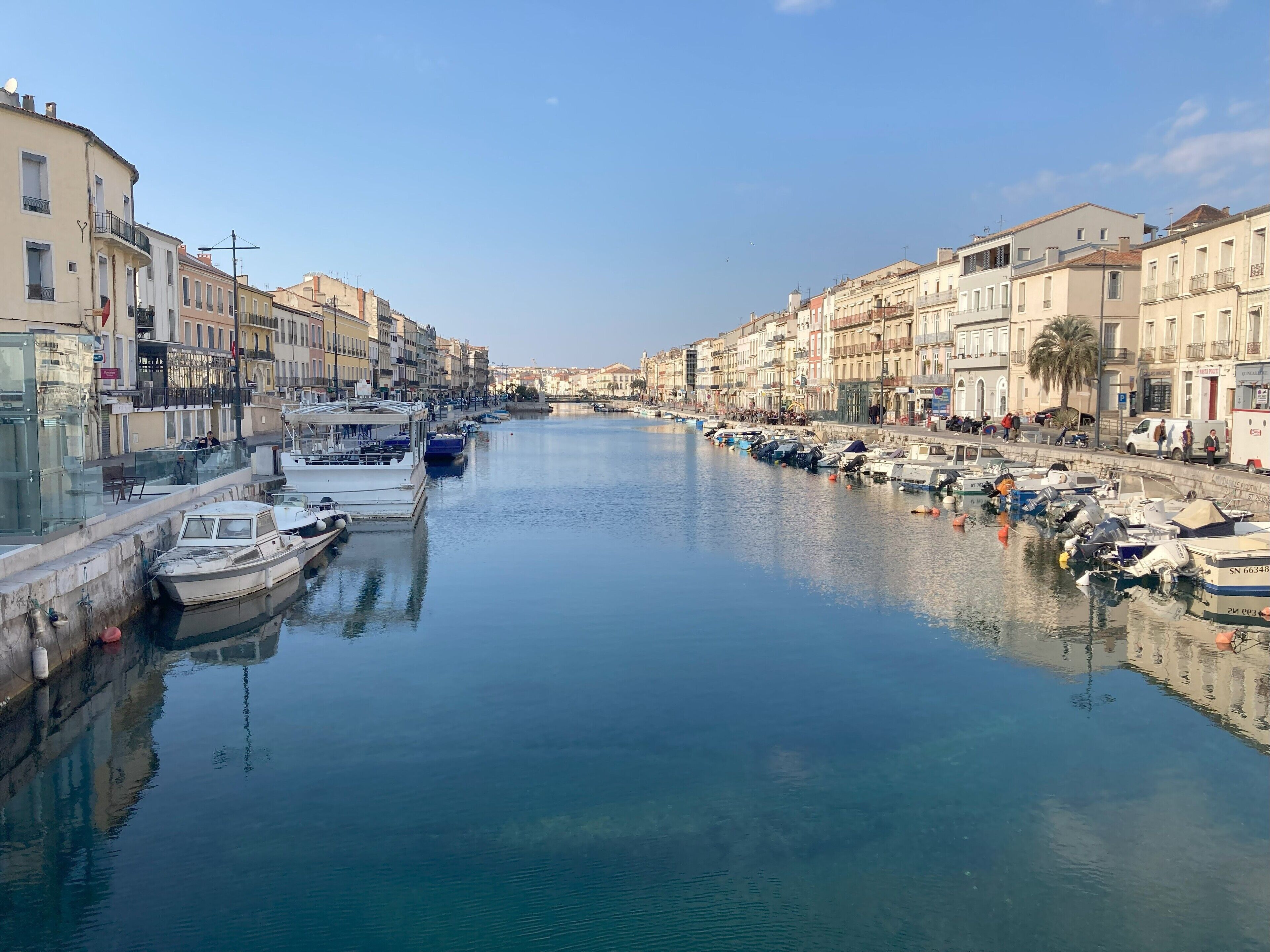 A canal lined with boats and buildings on both sides.