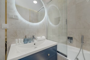 Shower, hair dryer, towels, shampoo