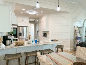 Enjoy cooking in this well-lit kitchen with a central island and bar stools.