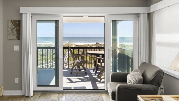 A room with a sliding glass door leading to a balcony with a view of the ocean. - The best Views On The Beach From This 3rd Floor Oasis!! (St. Augustine)