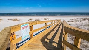 A wooden boardwalk leading to a beach with clear skies. - Stunning views from this top floor three bedroom condo! (Saint Augustine)