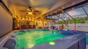A hot tub with a ceiling fan, string lights, and a view of the outdoors. - Heated Pool & Hot Tub | Game Room | Near AMI (Bradenton)