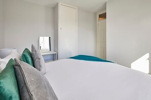 A bedroom with a large bed, a wardrobe, and a mirror. - Host & Stay | Bartlemere House (Barnard Castle)