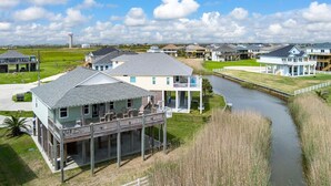 A waterfront property with multiple houses, a dock, and a canal.