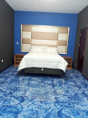 In-room safe, desk, laptop workspace, blackout curtains. Hotel Comfort