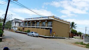 A multi-story building with a balcony on the upper floor.