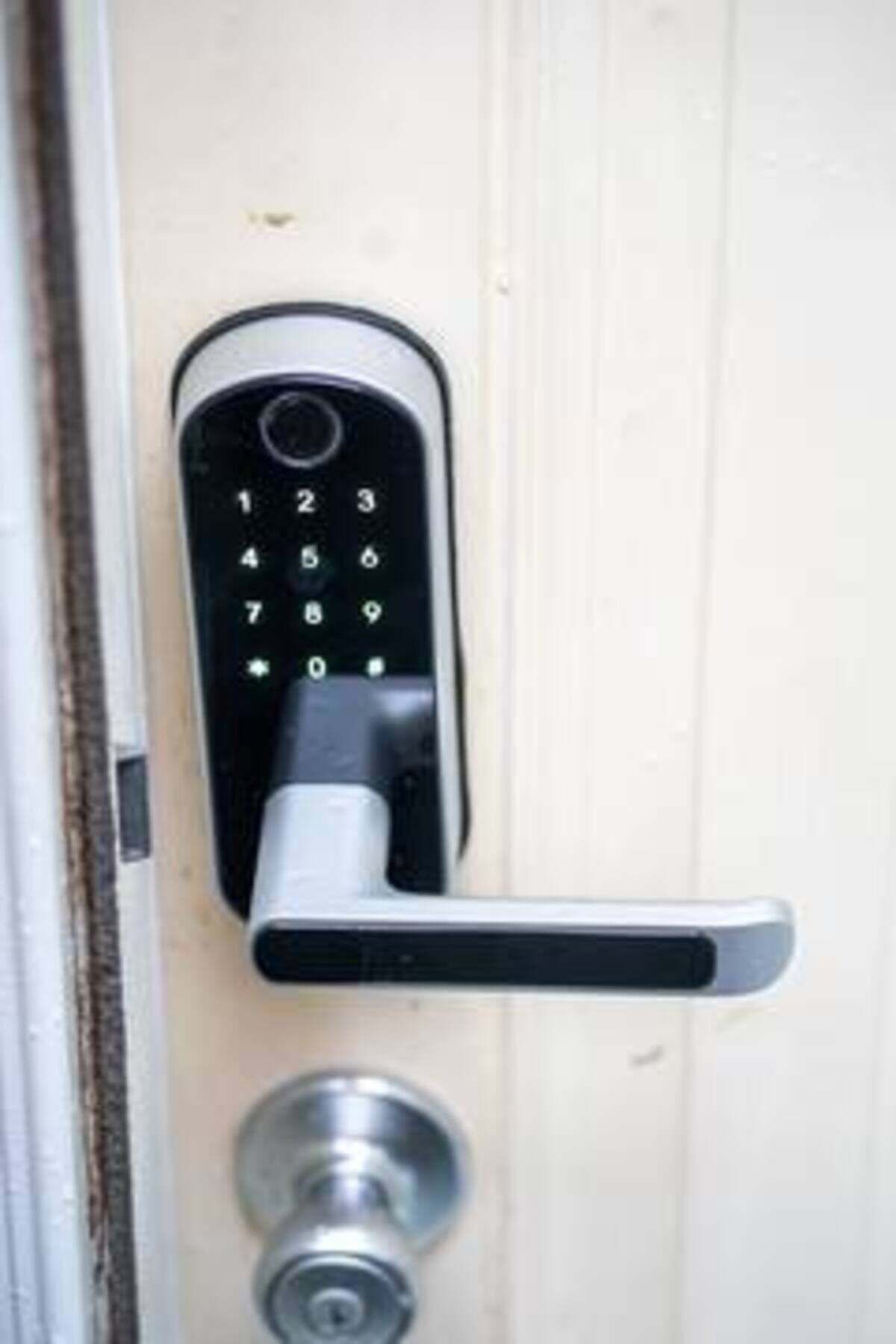 A door with a numeric keypad lock and a lever handle.