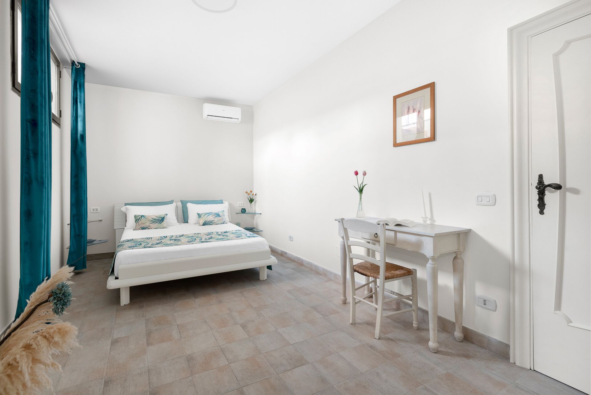 Un dormitorio con cama, escritorio y silla.