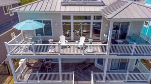 A two-story house with a balcony and a deck. - The Strand: Free Golf Carts, Paddle Boards, Tennis & Pool, 1 Blk to Beach (Cape Charles)