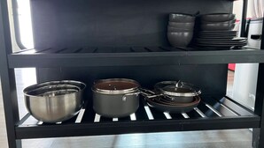 A kitchen shelf with cookware and dishes. - Open concept modern home: about 20 minutes or less to Disney,Malls, Beaches, etc (Santa Ana)
