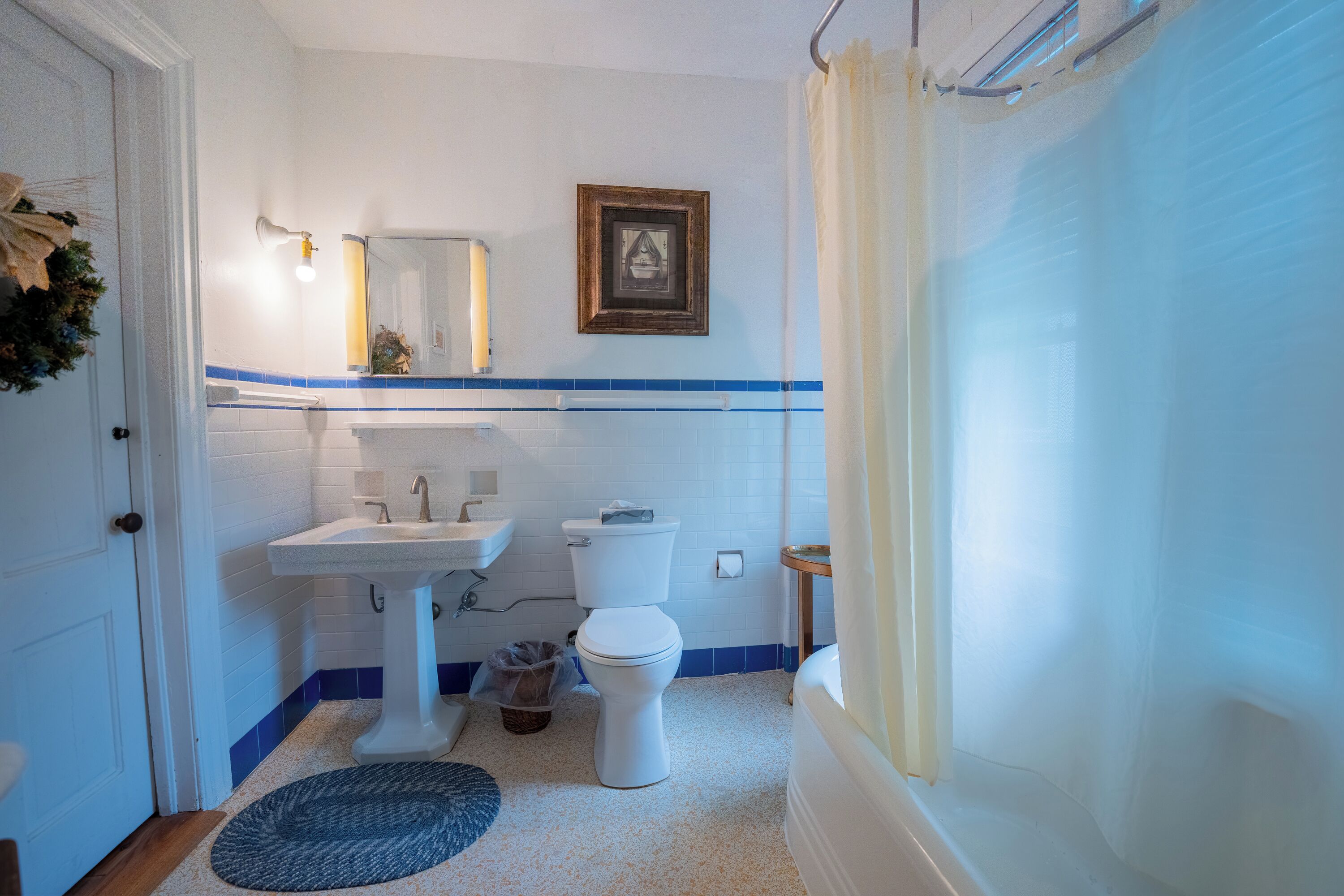 A bathroom with a white sink, a toilet, and a shower curtain.
