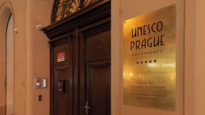 A door with a plaque for Unesco Prague Apartments, a security camera, and a fire alarm. - Unesco Prague Apartments (Prague)