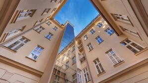 A multi-story building with a modern glass facade and traditional architecture. - Unesco Prague Apartments (Prague)