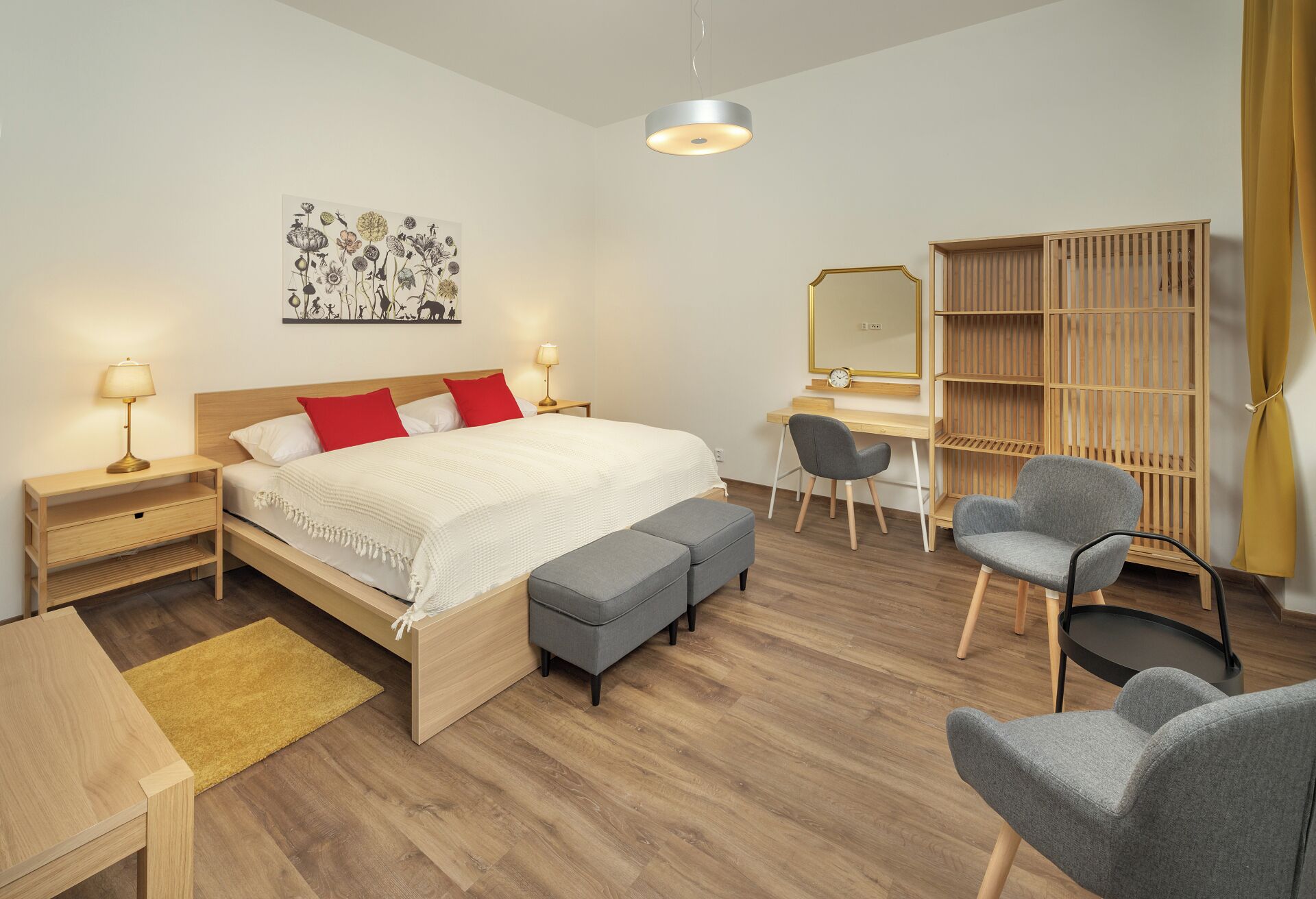 A modern bedroom with a bed, bedside tables, a desk, a chair, a wardrobe, and a hanging light fixture.