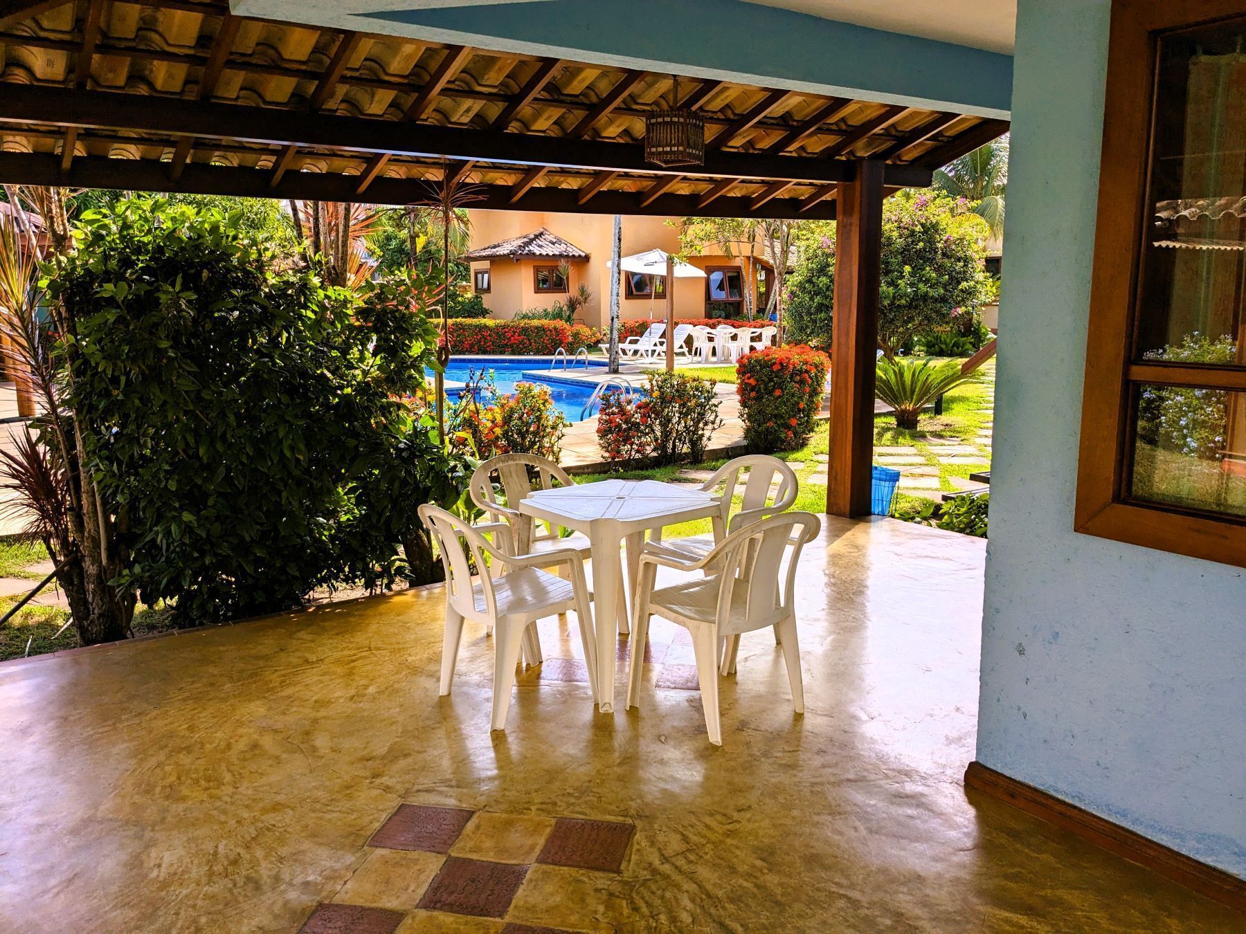 A covered patio with a pool and outdoor seating area.