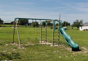 A playground with swings and a slide. - Lakefront home - country setting - just a little piece of paradise.  (Clermont)