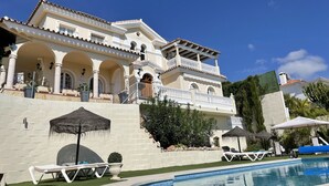 A large, two-story building with a pool, featuring a balcony and outdoor seating area. - Malagasuite Villa Moriana (Mijas Pueblo)