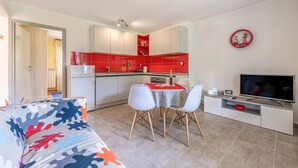 A compact living space with a kitchenette, a dining area, and a seating area with a sofa and chairs. - 2 bedroom awesome apartment in Pazin (Pazin)