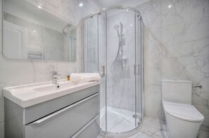 Shower, hair dryer, towels, toilet paper