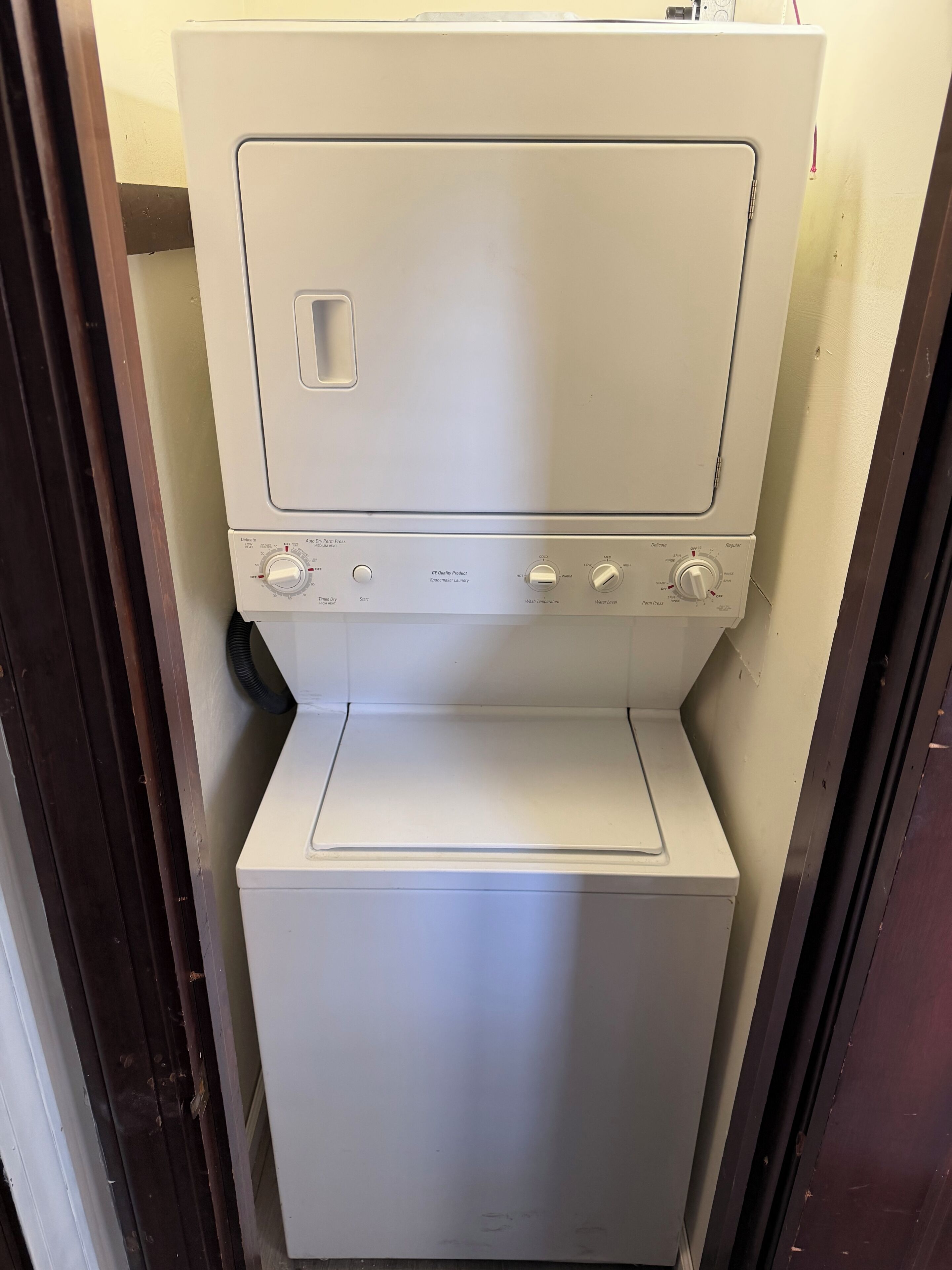 A compact, white, front-loading washing machine with a control panel featuring multiple settings.
