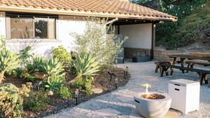 A patio area with a pergola, outdoor seating, and a fire pit. - Luxury Retreat, views of Monserate Winery (San Diego County)