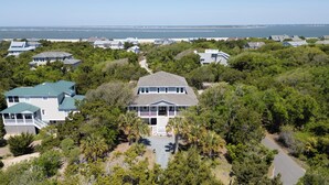 A large, two-story house with a porch and a view of the ocean. - Chic Shellter, Bald Head Island, NC (Bald Head Island)