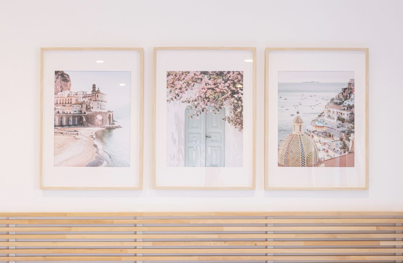 Three framed artworks on a wall.