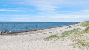 A sandy beach with a clear sky and calm sea. - 2 bedroom gorgeous home in Nakskov (Nakskov)