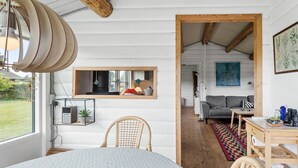 A cozy interior with a dining area, a sofa, and a view of the outdoors. - 2 bedroom gorgeous home in Nakskov (Nakskov)