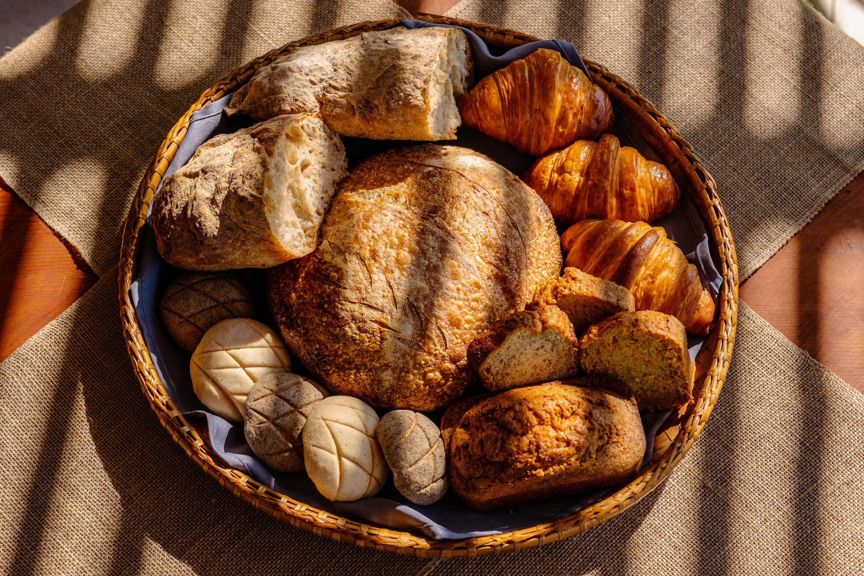 A basket of various breads and pastries.