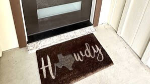 A modern door with frosted glass panels and a keypad lock.