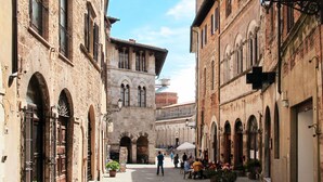 A narrow street with historic buildings, a central open area, and outdoor seating for cafes. - Cosy apartment in villa for 2 guests with WIFI, A/C, TV, terrace and pets allowed (Massa Marittima)