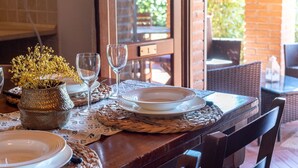 A dining table set with plates, glasses, and a decorative vase. - Cosy apartment in villa for 2 guests with WIFI, A/C, TV, terrace and pets allowed (Massa Marittima)