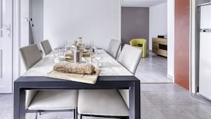 A modern dining area with a marble table, leather chairs, and a central bread roll. - bonnegrace by Interhome (Six Fours)