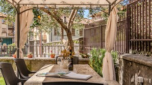 An outdoor patio with a table, chairs, and a pergola.