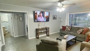 A living room with a television, sofa, and coffee table.