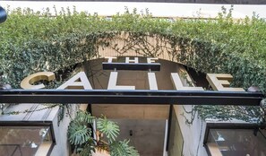 A building entrance with the words 'THE CALILE' visible above the door.