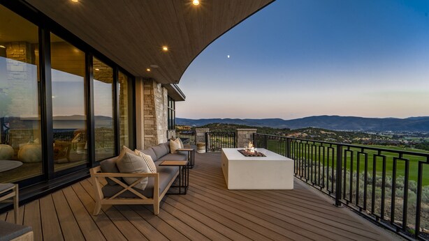 A wooden deck with outdoor furniture, a fire pit, and a view of the landscape. - Red Ledges luxury escape, golf, min 90 day stay (Heber City)