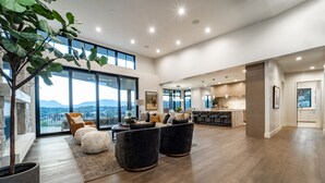 A spacious living area with a large window, a dining area, and a kitchen. - Red Ledges luxury escape, golf, min 90 day stay (Heber City)