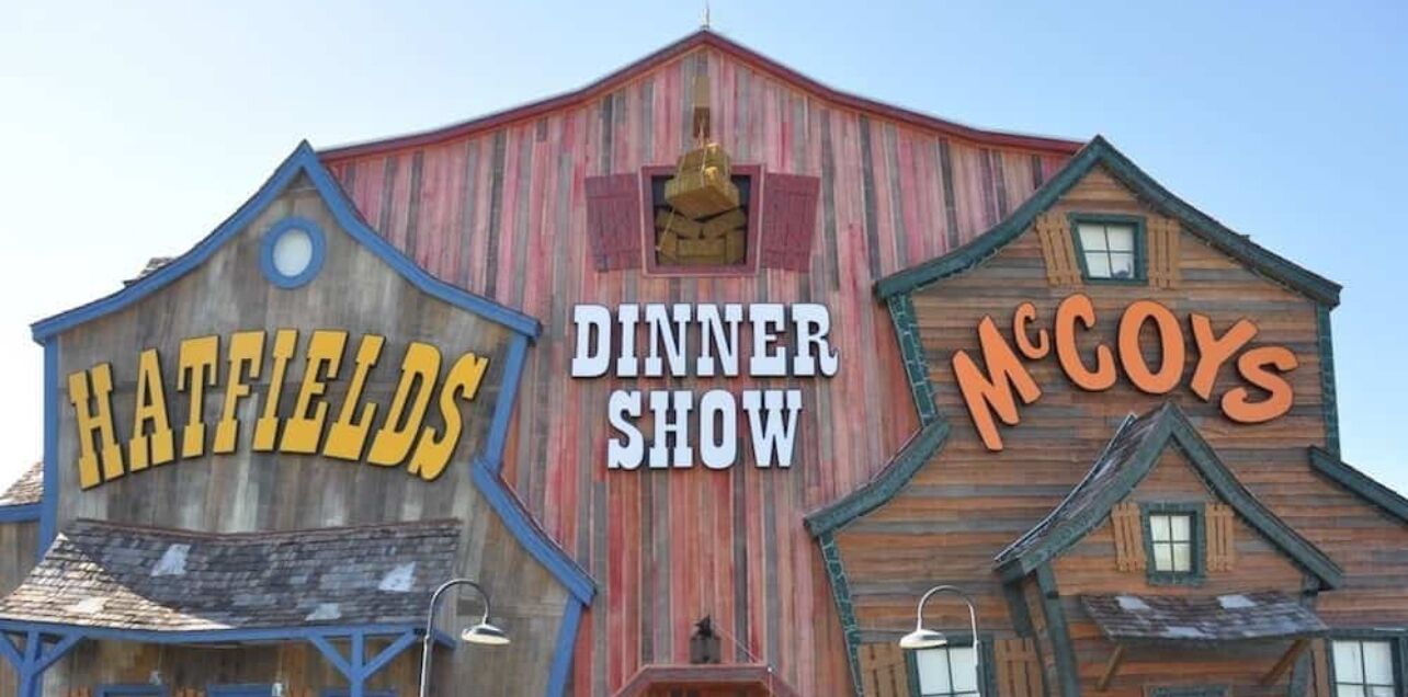 A building with signs for "Hatfields" and "McCoys" and a "Dinner Show" sign.
