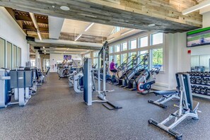 A gym with cardio machines, weightlifting equipment, and dumbbells. - Bayside Resort:  Beautiful 5 Bedroom House with 3. (Selbyville)