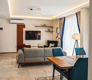 Deluxe Apartment | Living area | 43-inch LED TV with cable channels, pay movies