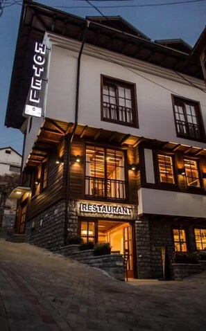 A two-story building with a sign indicating it is a restaurant. - Hotel Prizreni (Prizren)