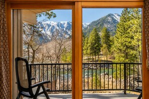 A balcony with a view of a river and mountains. - Riverside Lodge | Live Local | River | Hot Tub (Leavenworth)