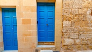Two blue doors with a stone wall and steps leading up to them. - Stay inside the walls of Gozo Cittadella fortress (Ir-Rabat Għawdex)