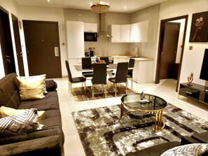 Relax in a cozy living area with a comfortable sofa and stylish coffee table, and enjoy a modern kitchen with contemporary appliances.