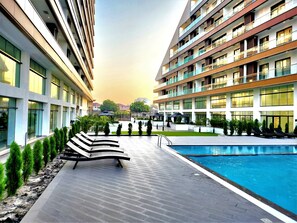 Relax by the clear pool surrounded by lounge chairs and take in the views from the spacious balcony.