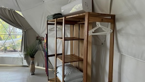 A tent with a wooden bunk bed, a white air conditioner, and a plant in the corner. - Amaj Eco Lodge (Sámara)