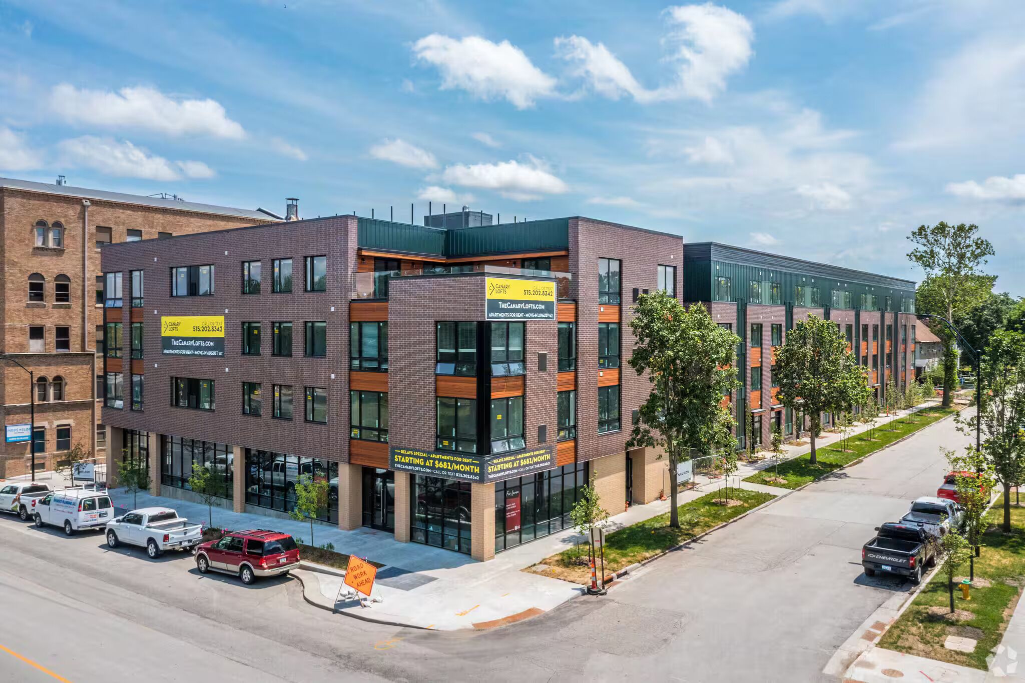 A multi-story building with a modern architectural design, featuring large windows and a brick facade.